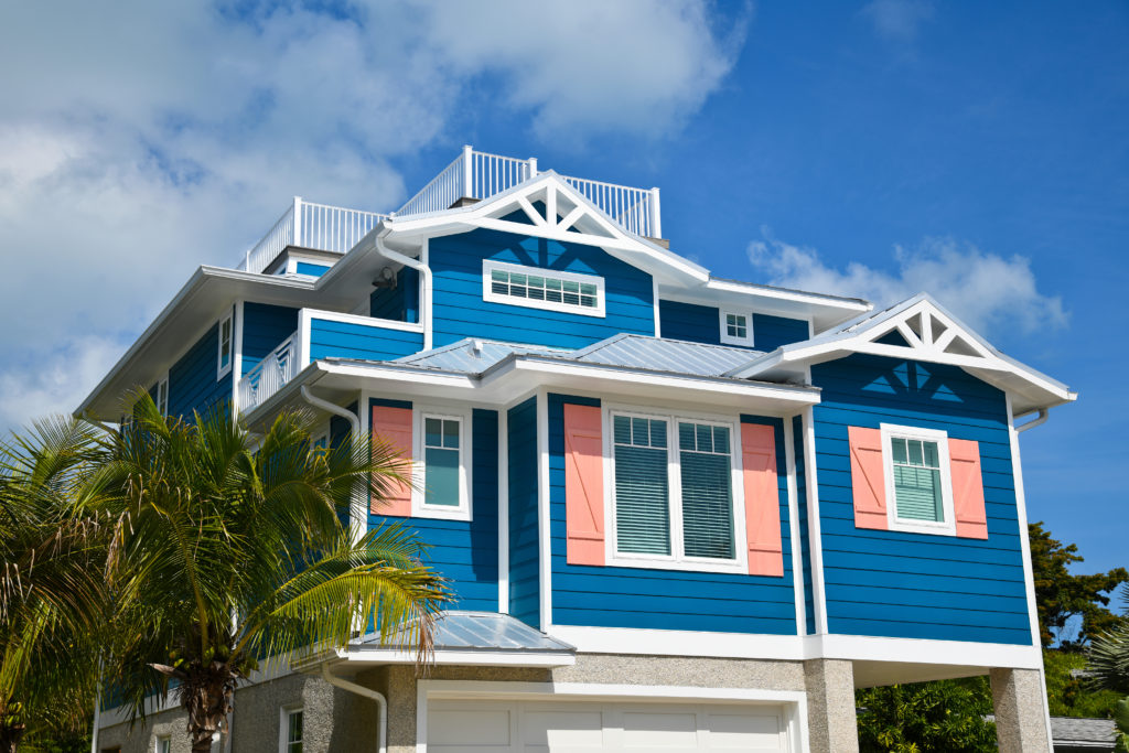 Large Beach House Painted In Dark Blue With White Trim And Coral - US ...