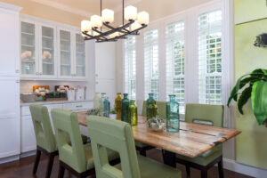 Picture of white plantation shutters installed in a dining room.