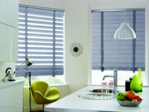 Picture of gray window shades installed next to a dining table.